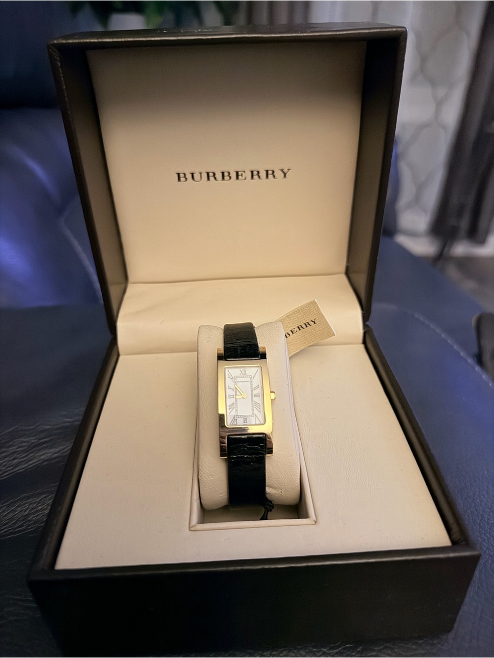 Woman’s Burberry Gold-Tone Rectangular Watch with Black Leather Strap with tag.